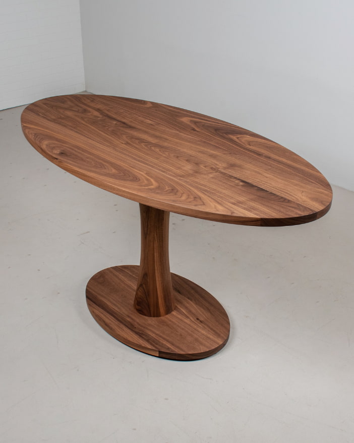 racetrack oval table made of solid wood on single cross pedestal base