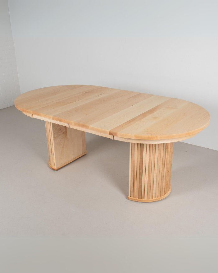 an expandable table on fluted pedestal base