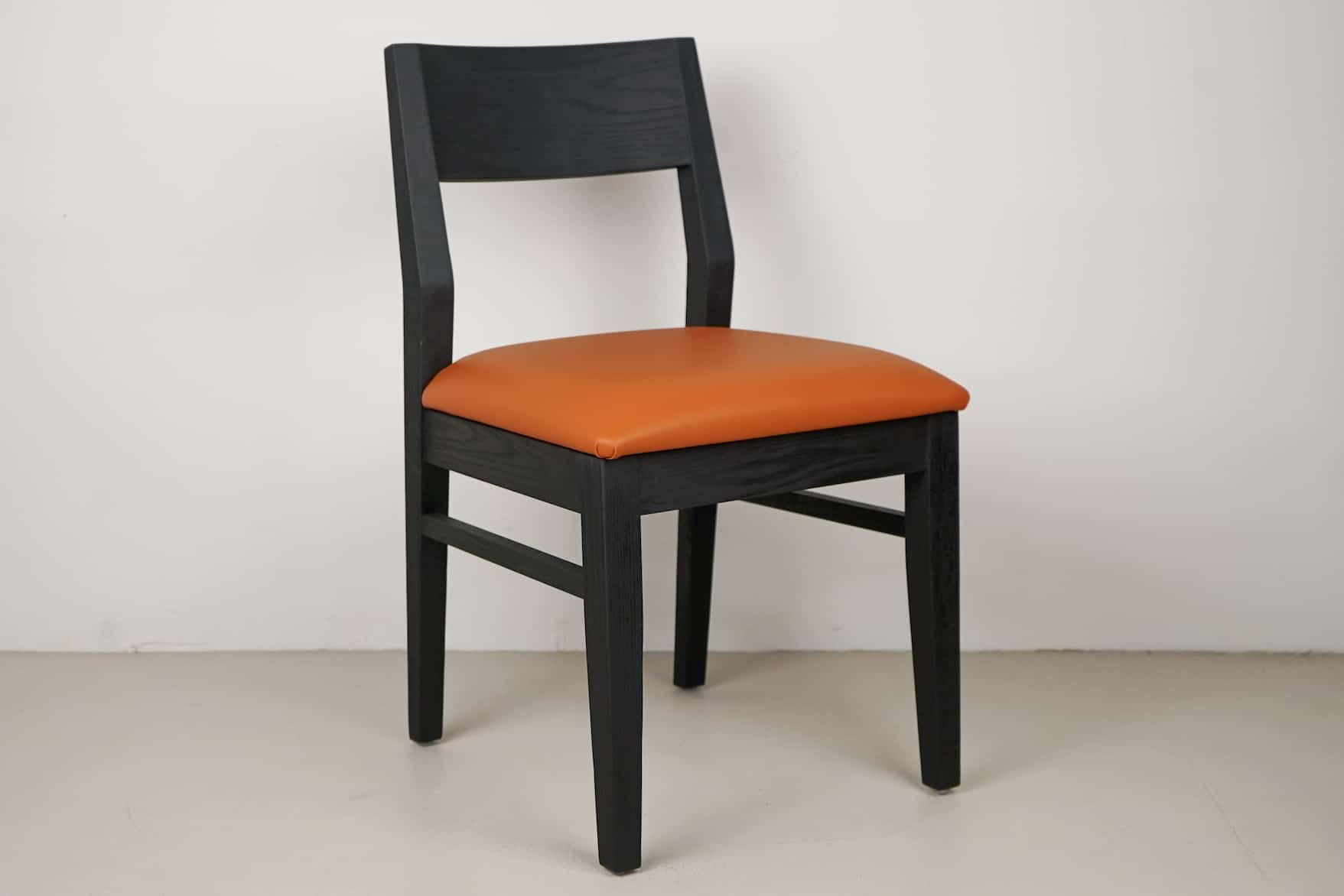 oak aubrey chairs in black with pumpkin seats