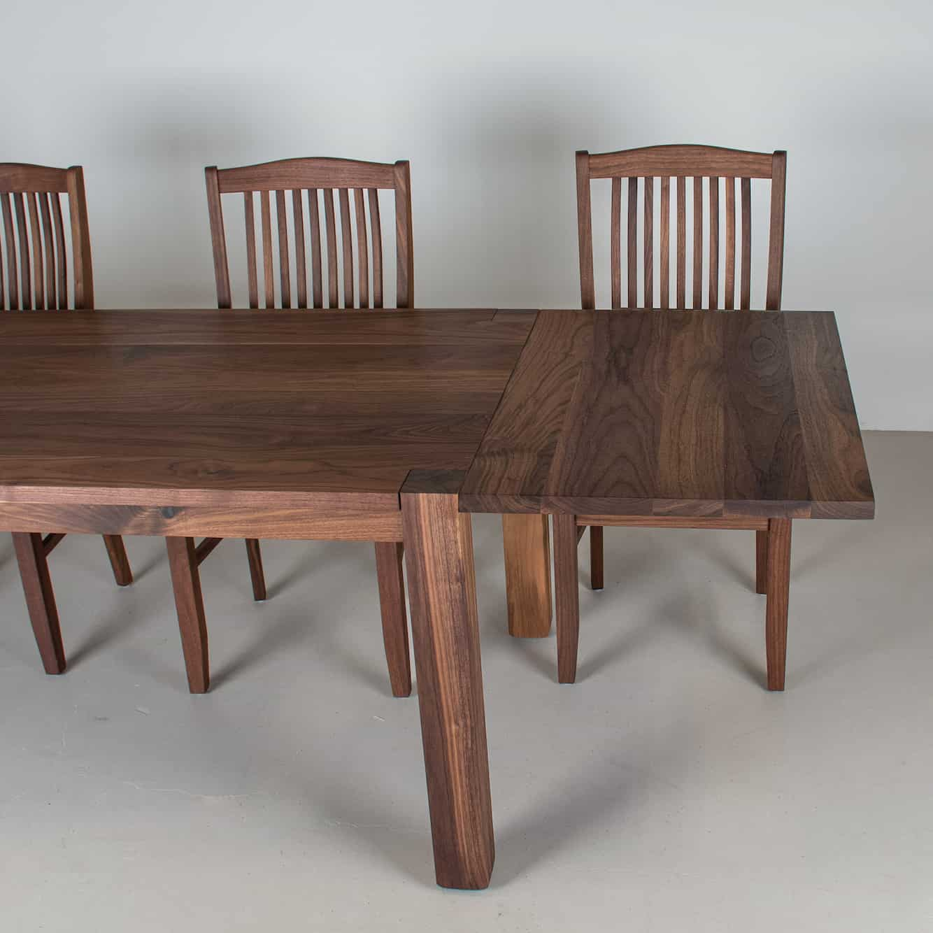 end of walnut extension table with chairs