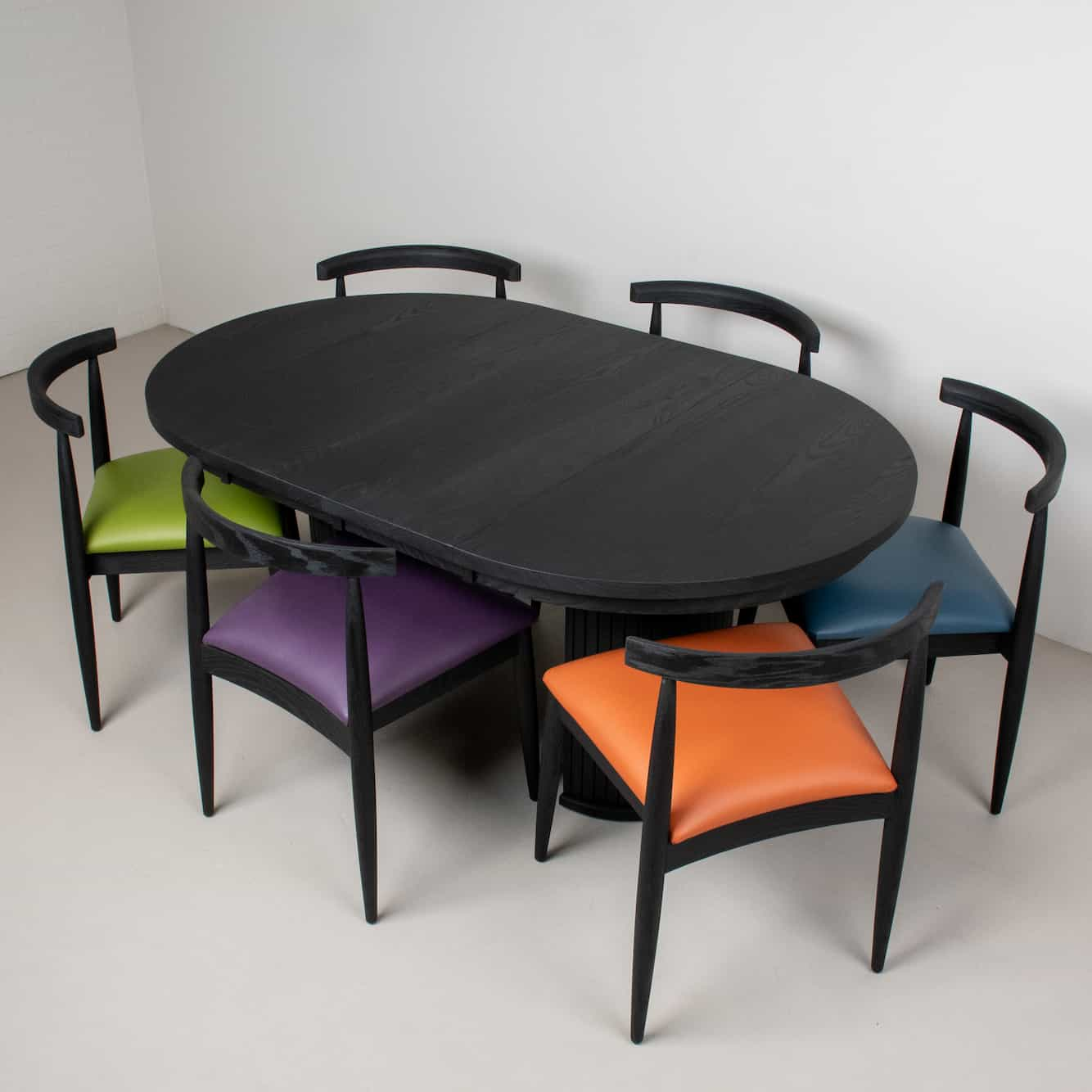 black oval table with dining chairs