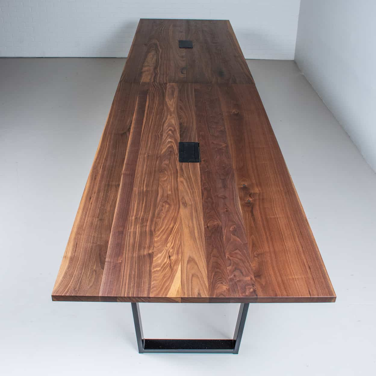 long walnut conference table on steel legs