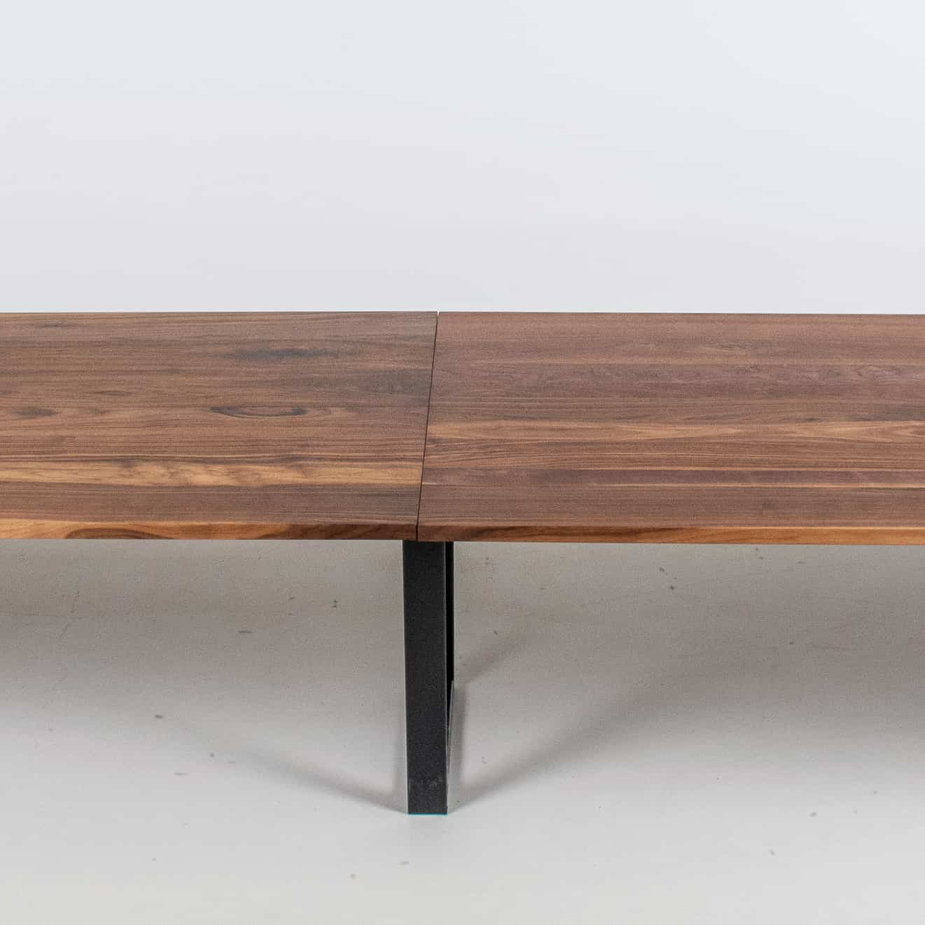 long walnut conference table on steel legs