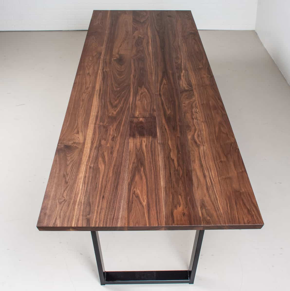 long walnut conference table on steel legs