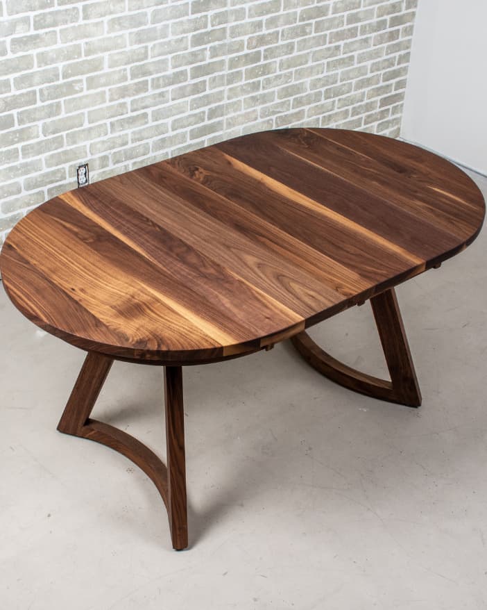 round walnut table on walnut legs