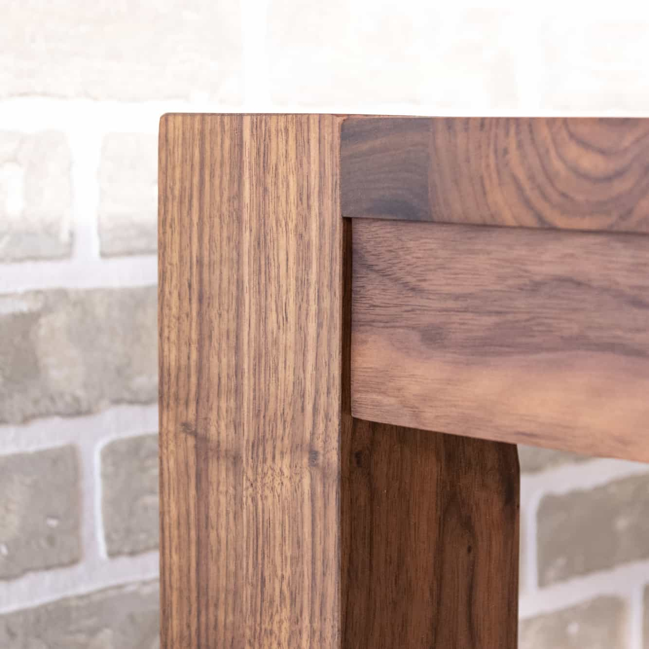 corner detail of modern walnut parsons table