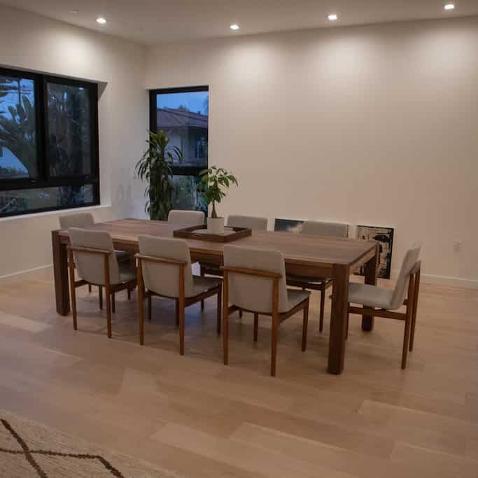 large modern walnut parsons table in a home