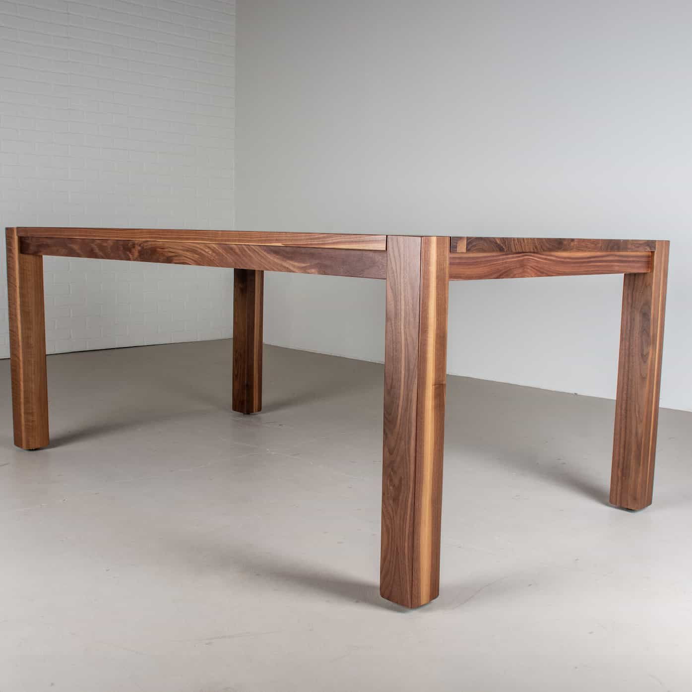 profile view of a walnut parsons table