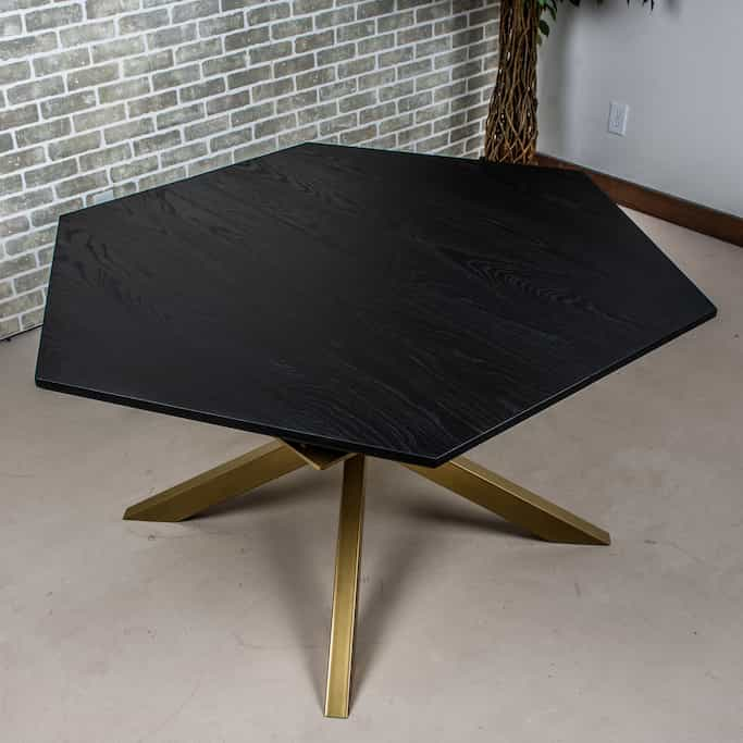 black hexagon table on gold legs