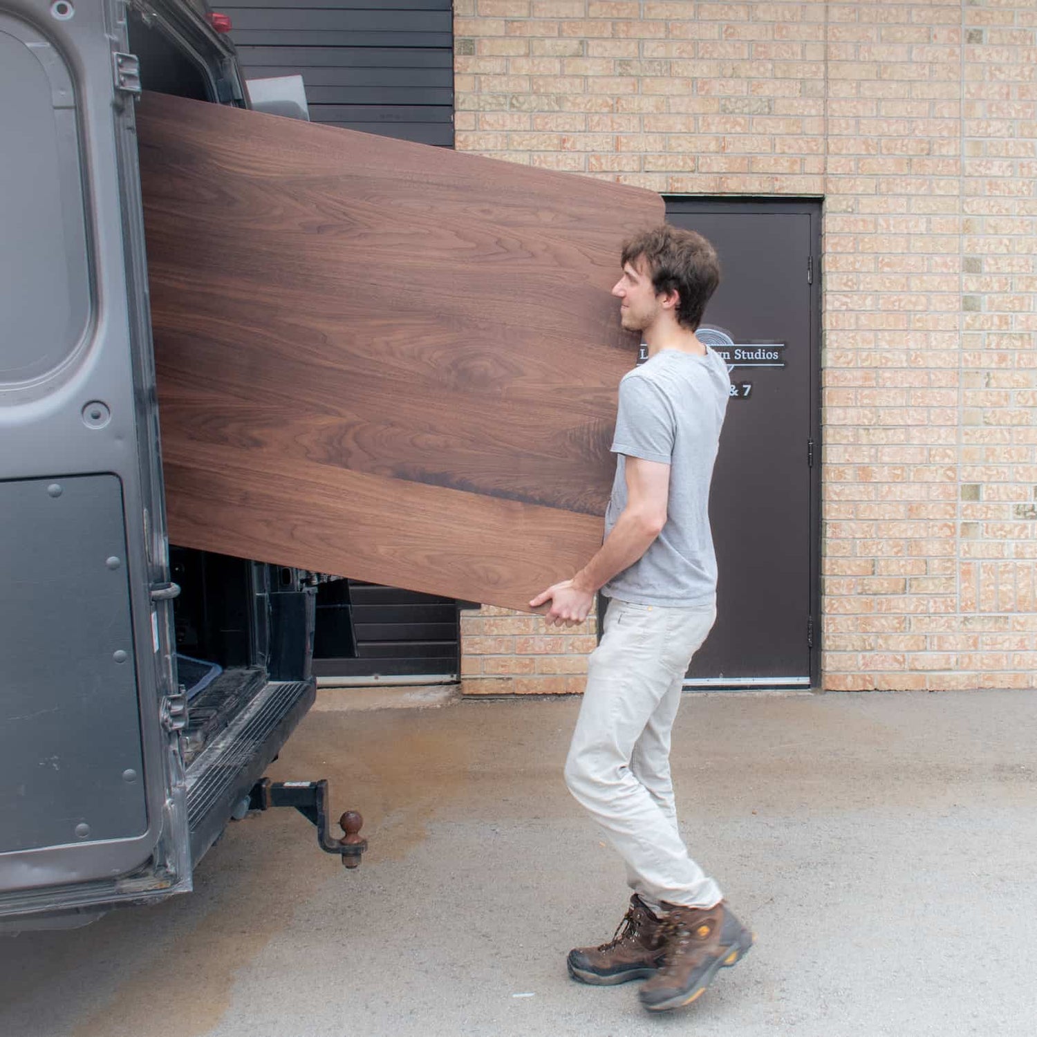 loading a wood table into a van