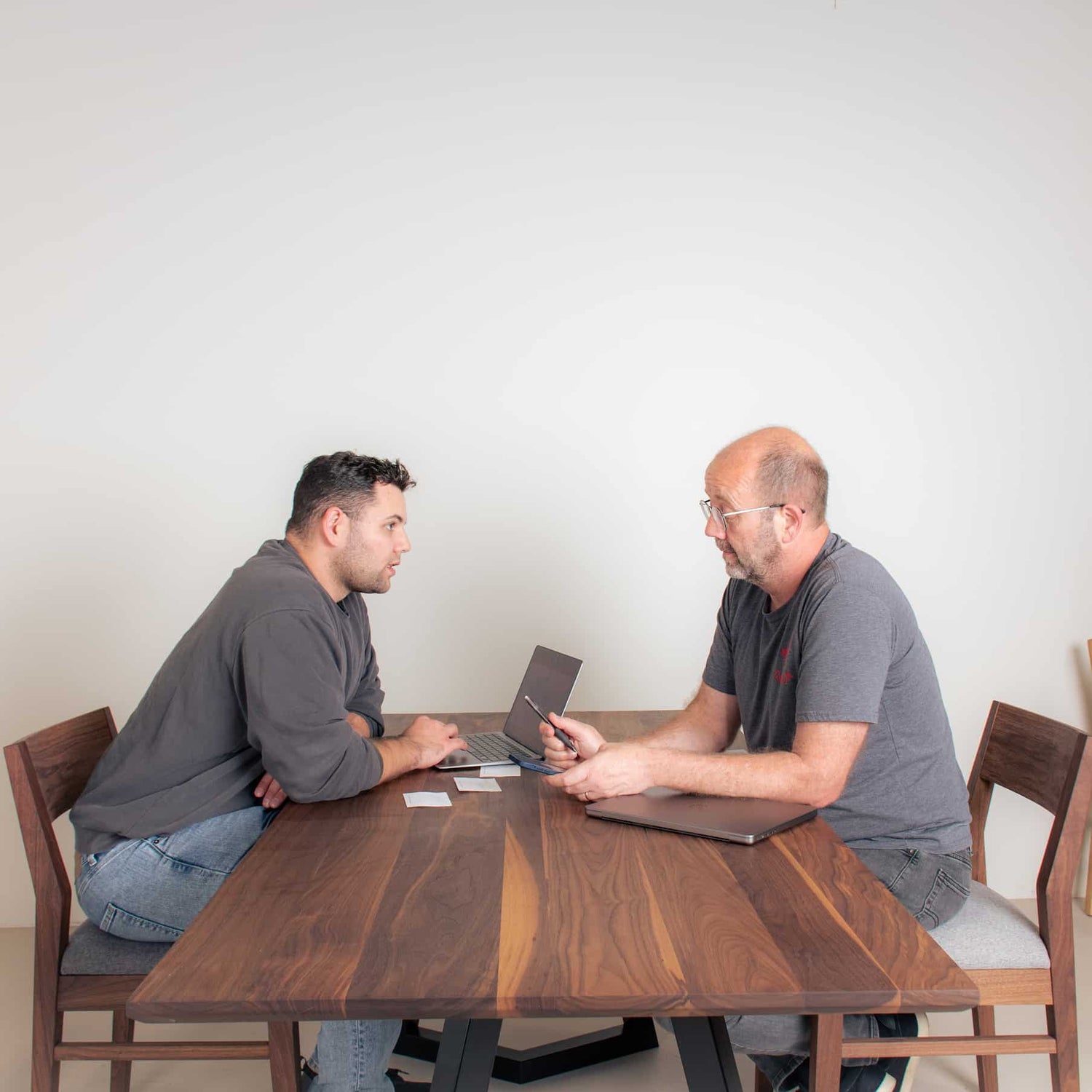 two people sit at a table to consult about a table design