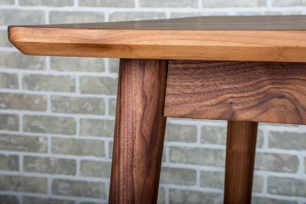 corner detail of walnut pinette table