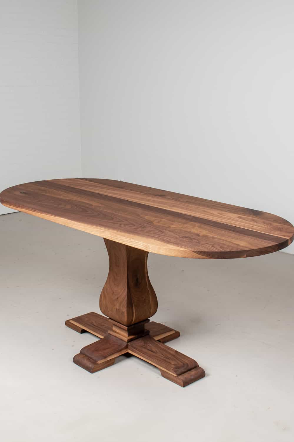 oval table on traditional pedestal base