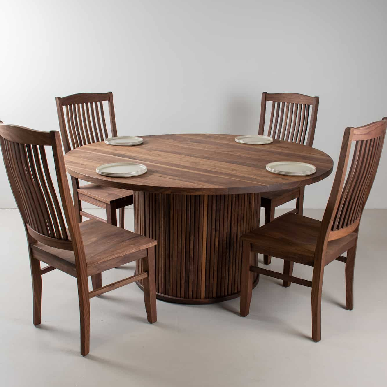 round walnut dining table with chairs