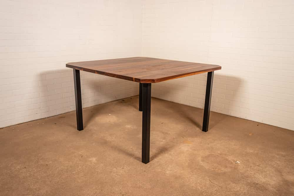 square walnut table with clipped corners on primrose legs